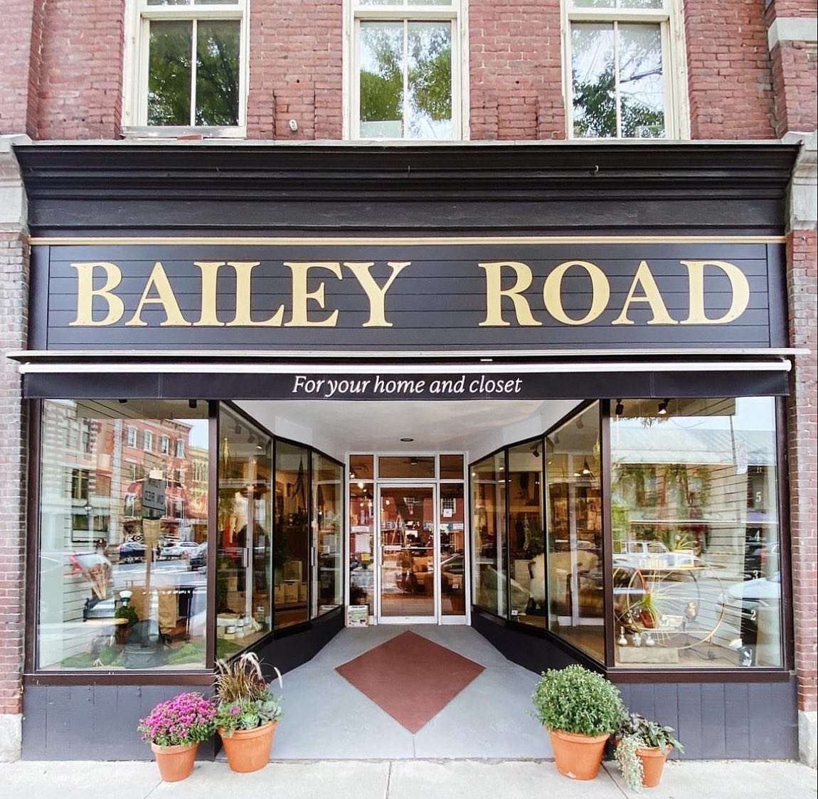 Bailey Road storefront in Montpelier, Vermont in the springtime with pots of flowers out front